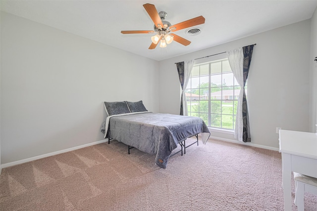 101 Wildrose St, Baytown, TX 77520 - carpeted bedroom with baseboards and a ceiling fan