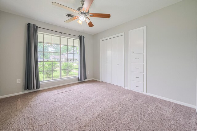 101 Wildrose St, Baytown, TX 77520 - unfurnished bedroom featuring carpet flooring, a closet, and a ceiling fan