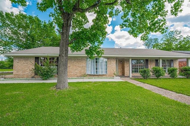 101 Wildrose St, Baytown, TX 77520 - ranch-style house featuring a front yard and brick siding