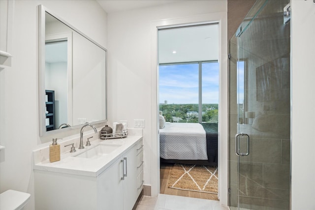 5656 San Felipe St Unit 606, Houston, TX 77056 - ensuite bathroom featuring vanity, a stall shower, and wood finished floors