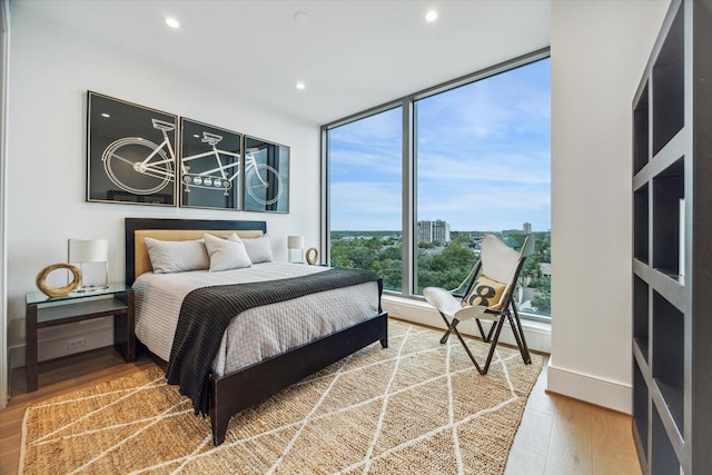5656 San Felipe St Unit 606, Houston, TX 77056 - bedroom with wood finished floors, recessed lighting, and floor to ceiling windows