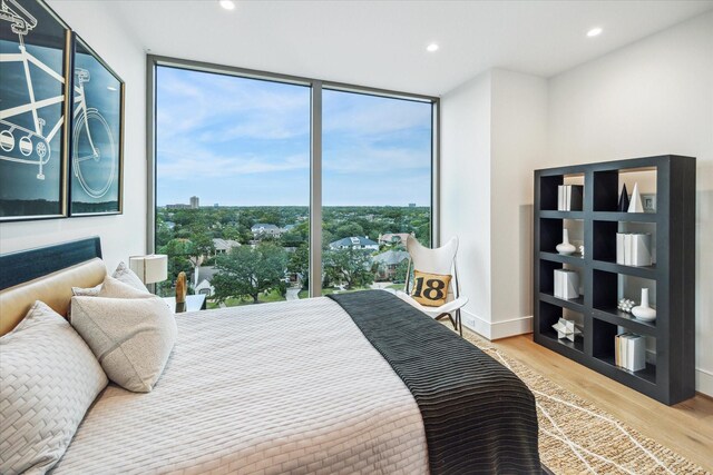 5656 San Felipe St Unit 606, Houston, TX 77056 - bedroom featuring multiple windows, expansive windows, wood finished floors, and recessed lighting