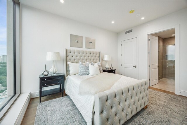 5656 San Felipe St Unit 606, Houston, TX 77056 - bedroom with recessed lighting, wood finished floors, and ensuite bath