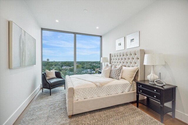 5656 San Felipe St Unit 606, Houston, TX 77056 - bedroom featuring expansive windows, wood finished floors, and recessed lighting