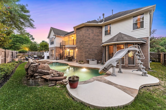 4607 Wellbrook Ln, Katy, TX 77450 - back of property featuring a balcony, a fenced backyard, brick siding, and a patio area