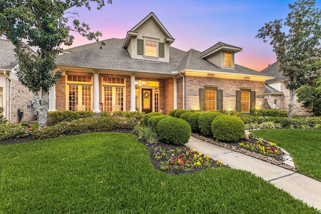 4607 Wellbrook Ln, Katy, TX 77450 - view of front facade with a front yard, brick siding, a shingled roof, and french doors