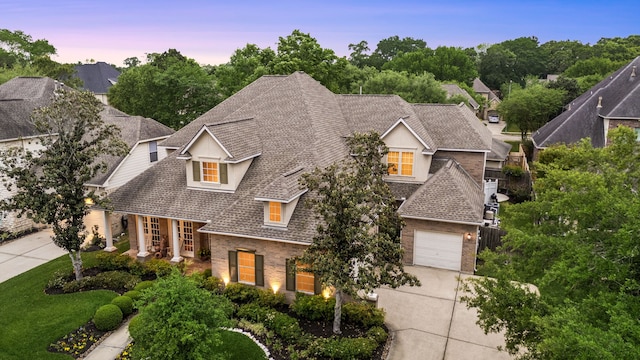 4607 Wellbrook Ln, Katy, TX 77450 - view of front of home featuring concrete driveway, brick siding, roof with shingles, and an attached garage