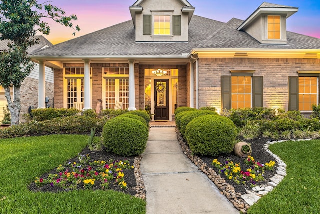 4607 Wellbrook Ln, Katy, TX 77450 - view of front of house with a shingled roof, brick siding, and a front yard