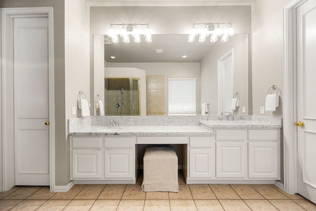 4607 Wellbrook Ln, Katy, TX 77450 - bathroom with a stall shower, double vanity, and tile patterned flooring