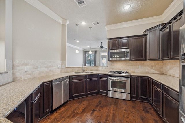 5708 Petty St Unit B, Houston, TX 77007 - kitchen featuring stainless steel appliances, crown molding, dark brown cabinetry, dark wood-style floors, and decorative backsplash