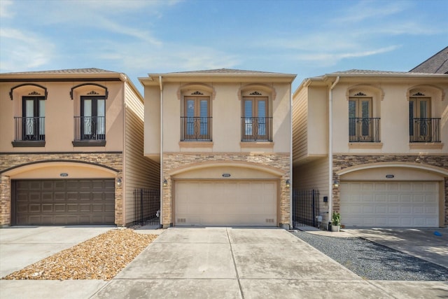 5708 Petty St Unit B, Houston, TX 77007 - view of property with a balcony, french doors, an attached garage, and stone siding