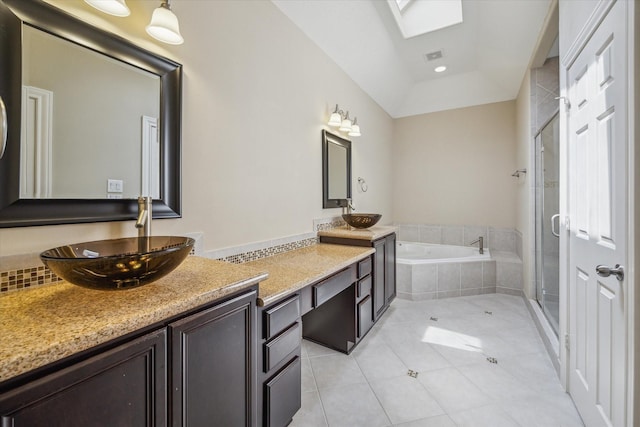 5708 Petty St Unit B, Houston, TX 77007 - full bathroom with tile patterned flooring, a garden tub, vanity, a shower stall, and a skylight