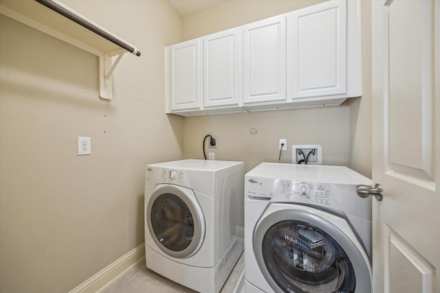 5708 Petty St Unit B, Houston, TX 77007 - laundry room with cabinet space, washing machine and dryer, and light tile patterned floors