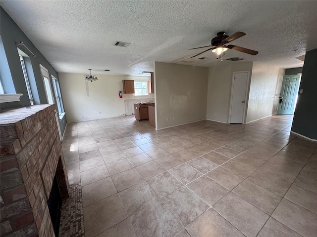 1629 Sylvia Ct, Round Rock, TX 78681 - unfurnished living room featuring a ceiling fan, a chandelier, light tile patterned floors, and a textured ceiling