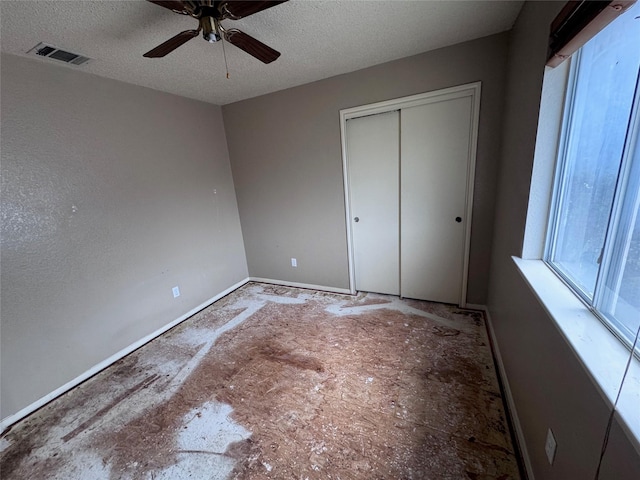 1629 Sylvia Ct, Round Rock, TX 78681 - unfurnished bedroom with a textured ceiling, a closet, and a ceiling fan