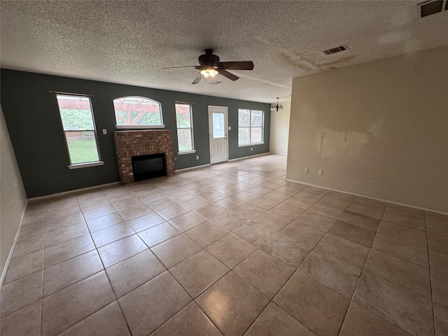 1629 Sylvia Ct, Round Rock, TX 78681 - unfurnished living room with a ceiling fan, a brick fireplace, a textured ceiling, and tile patterned flooring