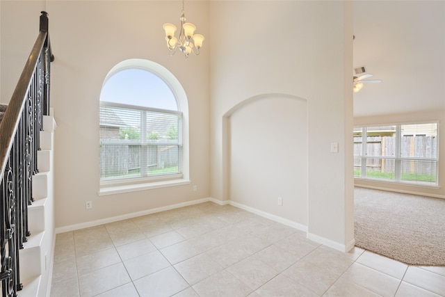 15315 Skyhill Dr, Cypress, TX 77433 - unfurnished room featuring plenty of natural light, a towering ceiling, a chandelier, light tile patterned floors, and ceiling fan