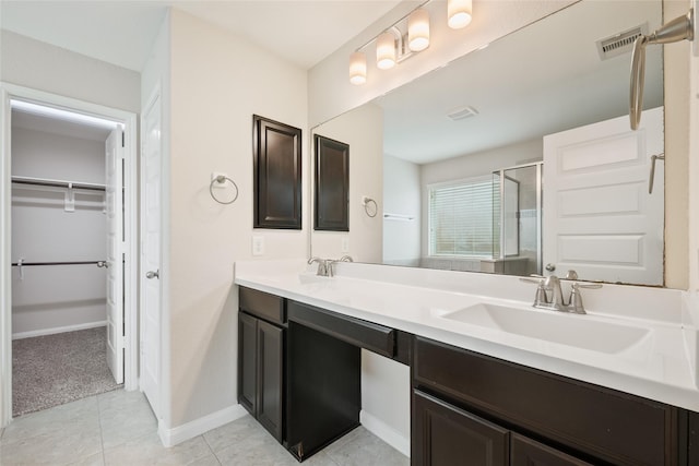 15315 Skyhill Dr, Cypress, TX 77433 - bathroom with a shower stall, double vanity, a walk in closet, and tile patterned flooring