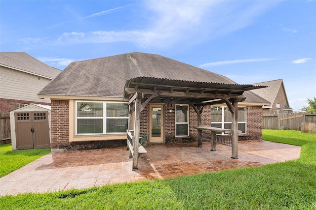 15315 Skyhill Dr, Cypress, TX 77433 - back of property with brick siding, a shed, a shingled roof, and a patio
