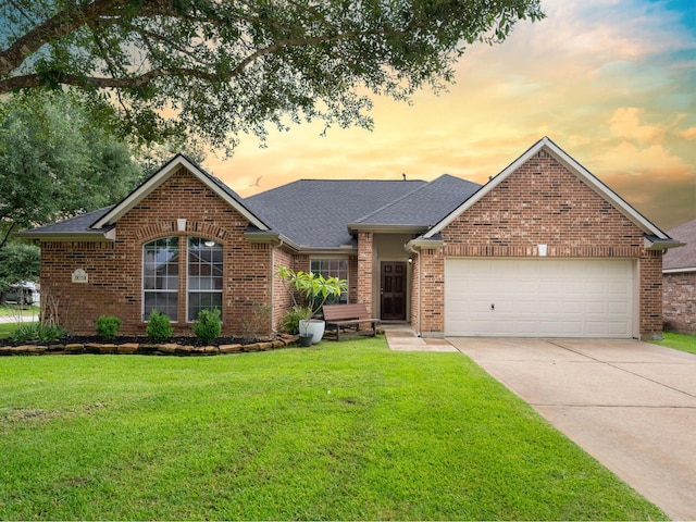 38318 E Sulphur Creek Dr, Magnolia, TX 77355 - view of front of house featuring an attached garage, driveway, a lawn, a shingled roof, and brick siding