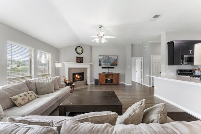 38318 E Sulphur Creek Dr, Magnolia, TX 77355 - living area featuring a tiled fireplace, dark wood-type flooring, a ceiling fan, and lofted ceiling