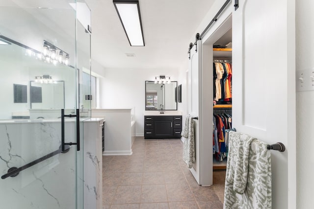 38318 E Sulphur Creek Dr, Magnolia, TX 77355 - bathroom with vanity, a stall shower, a garden tub, tile patterned floors, and a walk in closet