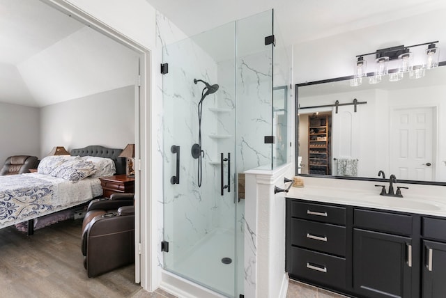 38318 E Sulphur Creek Dr, Magnolia, TX 77355 - ensuite bathroom featuring a marble finish shower, vanity, and wood finished floors
