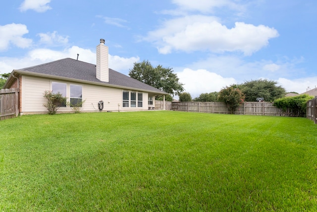 38318 E Sulphur Creek Dr, Magnolia, TX 77355 - rear view of house with a chimney and a fenced backyard