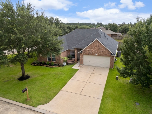 38318 E Sulphur Creek Dr, Magnolia, TX 77355 - traditional-style house with a shingled roof, brick siding, a garage, concrete driveway, and a front yard