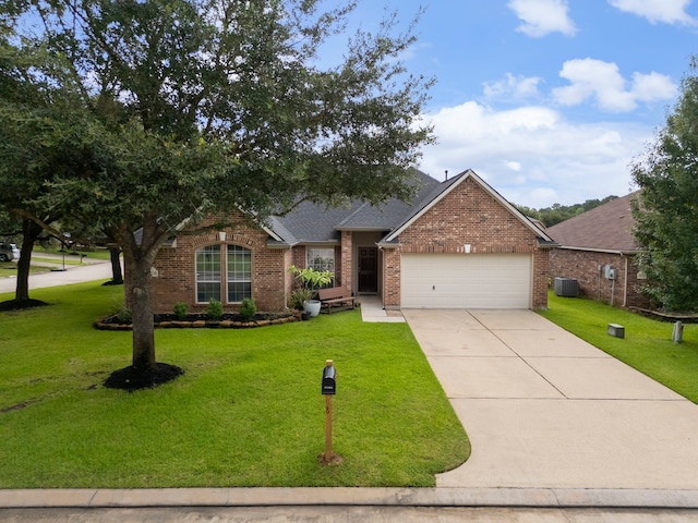 38318 E Sulphur Creek Dr, Magnolia, TX 77355 - view of front of home with brick siding, an attached garage, a front lawn, and driveway