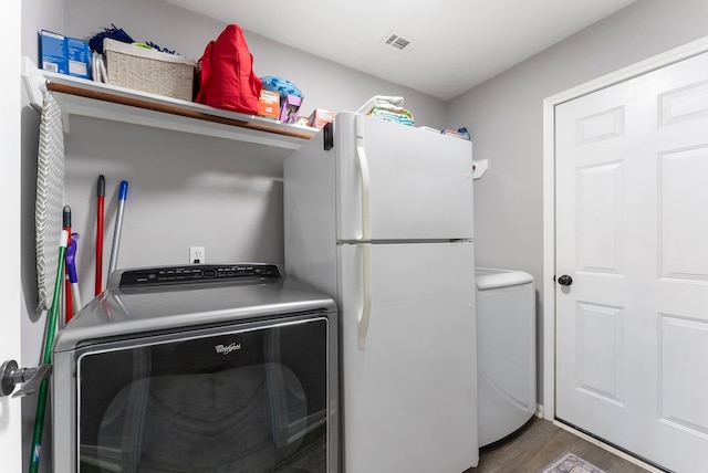 38318 E Sulphur Creek Dr, Magnolia, TX 77355 - laundry area featuring wood finished floors and washer and clothes dryer