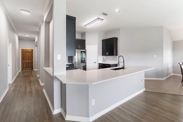 38318 E Sulphur Creek Dr, Magnolia, TX 77355 - kitchen with smart refrigerator, dark cabinetry, dark wood finished floors, light countertops, and recessed lighting