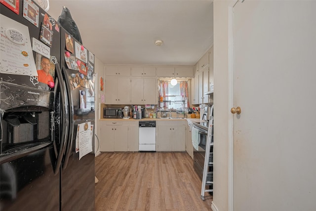 513 Frankie St, Wharton, TX 77488 - kitchen with black refrigerator with ice dispenser, dishwasher, stainless steel microwave, light countertops, and light wood-type flooring