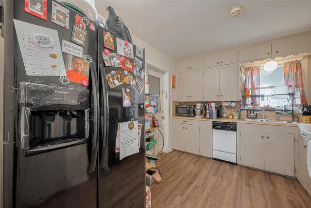 513 Frankie St, Wharton, TX 77488 - kitchen with refrigerator with ice dispenser, white dishwasher, stainless steel microwave, light wood-type flooring, and white cabinets