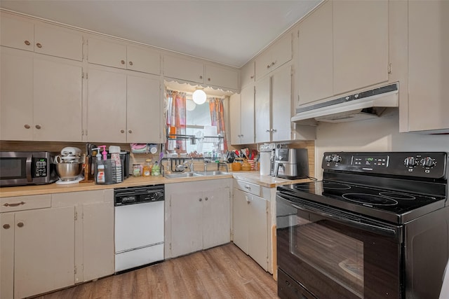 513 Frankie St, Wharton, TX 77488 - kitchen with black electric range, dishwasher, stainless steel microwave, under cabinet range hood, and light countertops