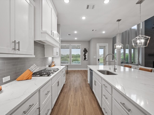 21310 Blue Wood Aster Ct, Cypress, TX 77433 - kitchen featuring appliances with stainless steel finishes, a chandelier, light wood-type flooring, white cabinets, and recessed lighting