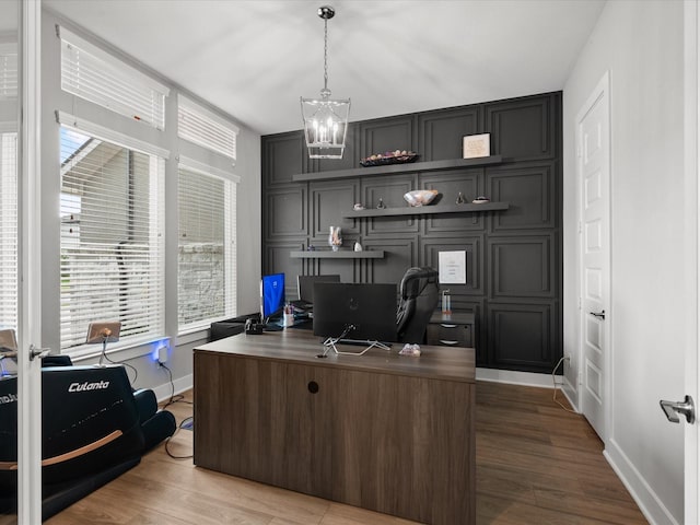 21310 Blue Wood Aster Ct, Cypress, TX 77433 - office space featuring a chandelier, wood finished floors, plenty of natural light, and a decorative wall