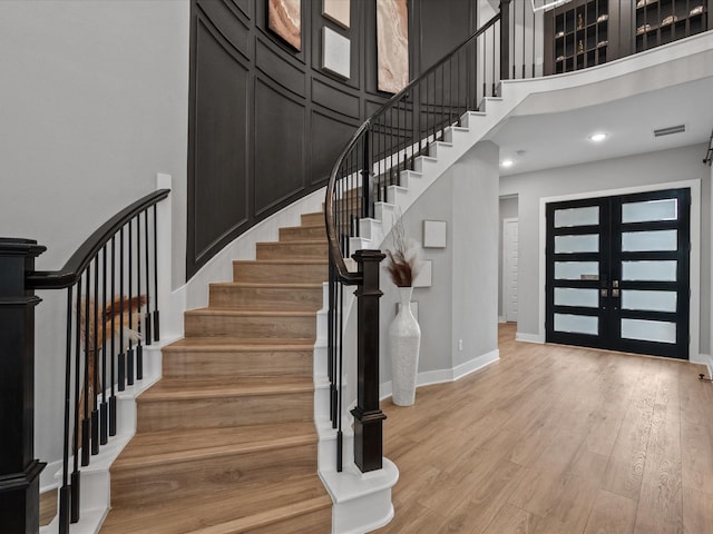 21310 Blue Wood Aster Ct, Cypress, TX 77433 - foyer entrance featuring light wood-type flooring, stairs, french doors, and a towering ceiling
