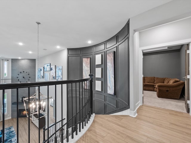 21310 Blue Wood Aster Ct, Cypress, TX 77433 - hall featuring an upstairs landing, wood finished floors, recessed lighting, and a decorative wall