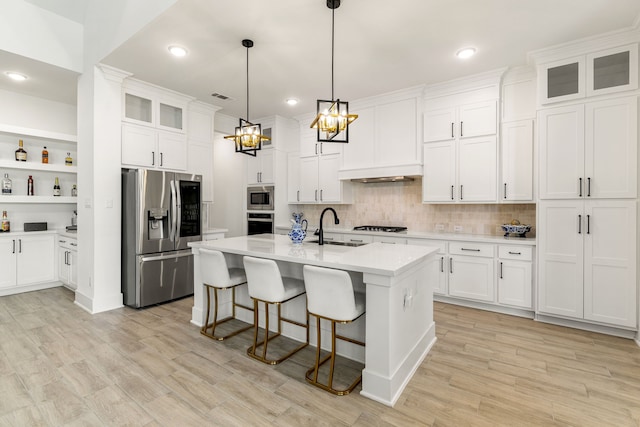 6523 Poplar Meadow Ln, Katy, TX 77493 - kitchen featuring appliances with stainless steel finishes, light countertops, a chandelier, a kitchen bar, and backsplash