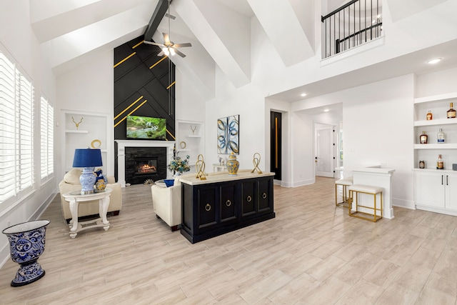 6523 Poplar Meadow Ln, Katy, TX 77493 - living room with high vaulted ceiling, built in features, a large fireplace, beamed ceiling, and light wood-style flooring