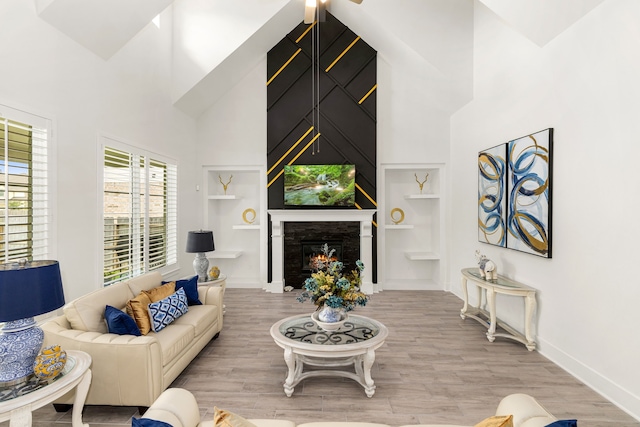 6523 Poplar Meadow Ln, Katy, TX 77493 - living area featuring a high ceiling, built in features, wood finished floors, and a large fireplace