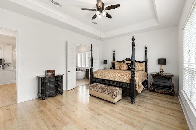 6523 Poplar Meadow Ln, Katy, TX 77493 - bedroom featuring a raised ceiling, multiple windows, light wood-type flooring, and ornamental molding