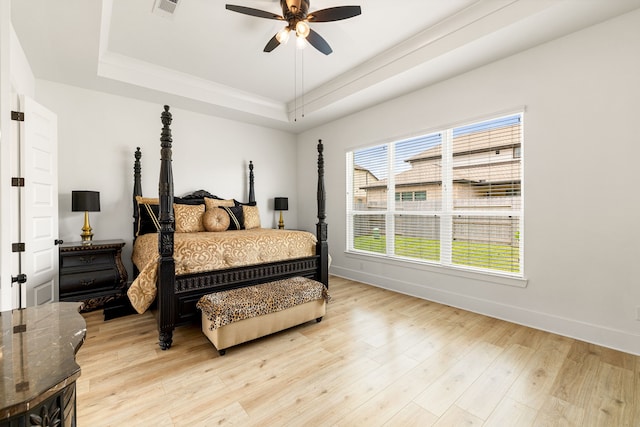 6523 Poplar Meadow Ln, Katy, TX 77493 - bedroom with a tray ceiling, light wood-style floors, and a ceiling fan
