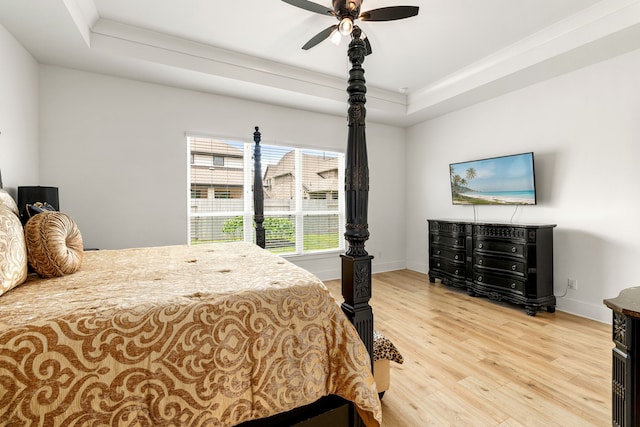 6523 Poplar Meadow Ln, Katy, TX 77493 - bedroom with a tray ceiling, wood finished floors, and ceiling fan