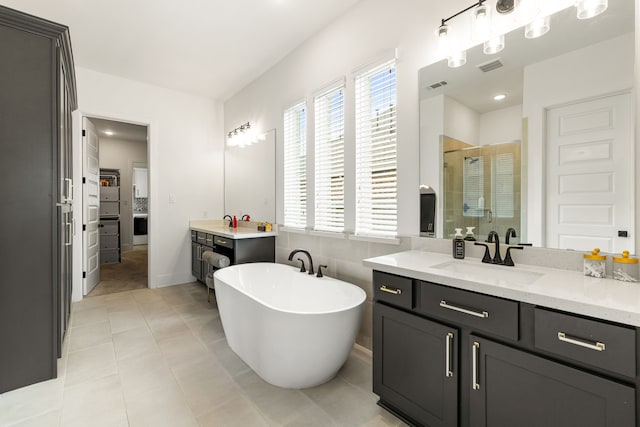 6523 Poplar Meadow Ln, Katy, TX 77493 - bathroom featuring a stall shower, vanity, a soaking tub, and tile patterned floors