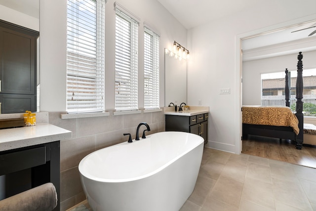 6523 Poplar Meadow Ln, Katy, TX 77493 - full bath with ensuite bathroom, a freestanding bath, vanity, and tile patterned flooring