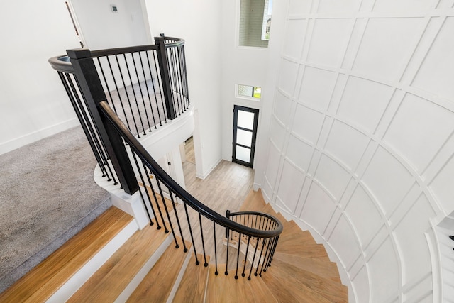 6523 Poplar Meadow Ln, Katy, TX 77493 - staircase with a decorative wall and wood finished floors