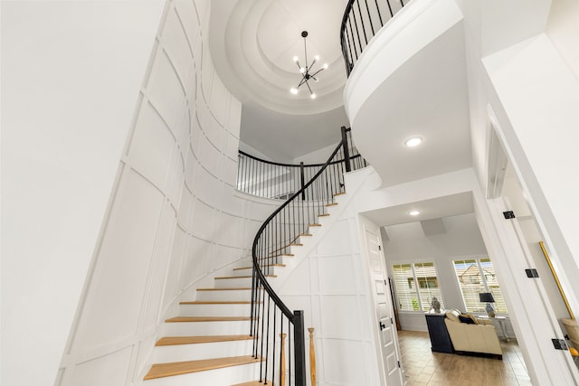 6523 Poplar Meadow Ln, Katy, TX 77493 - stairs featuring a towering ceiling, recessed lighting, a chandelier, and a decorative wall