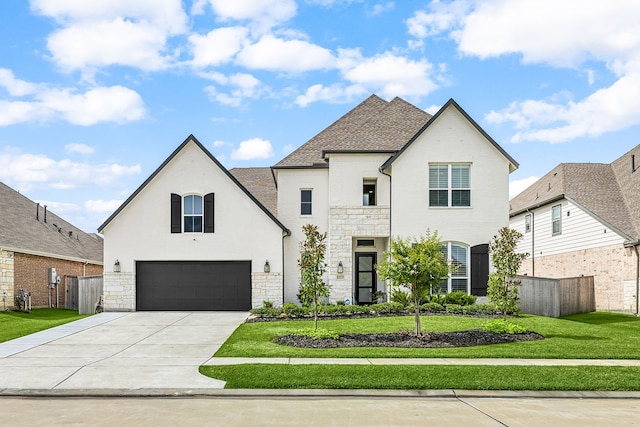 6523 Poplar Meadow Ln, Katy, TX 77493 - french country inspired facade featuring stone siding, an attached garage, and driveway